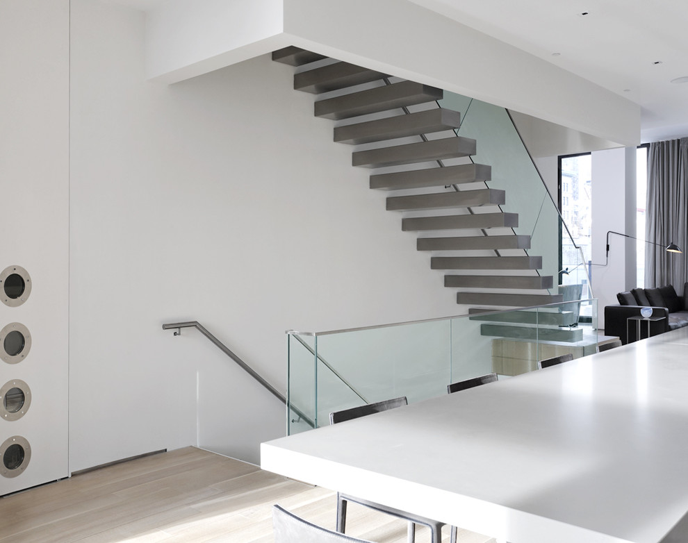 Design ideas for a contemporary floating staircase in New York with feature lighting.