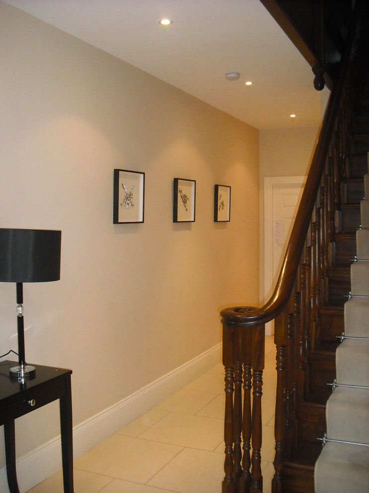 Inspiration for a large traditional carpeted straight wood railing staircase in Dublin with carpeted risers.