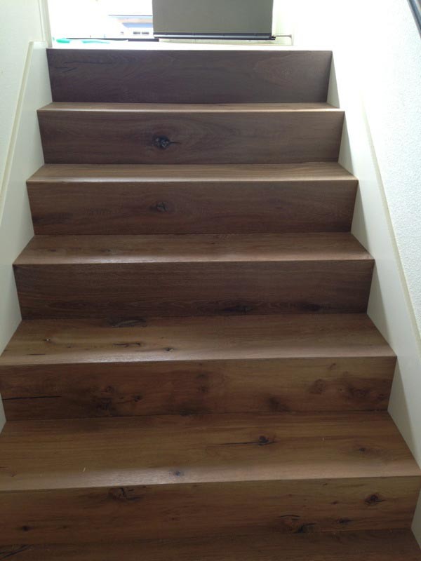 Minimalist wooden straight wood railing staircase photo in San Diego with wooden risers