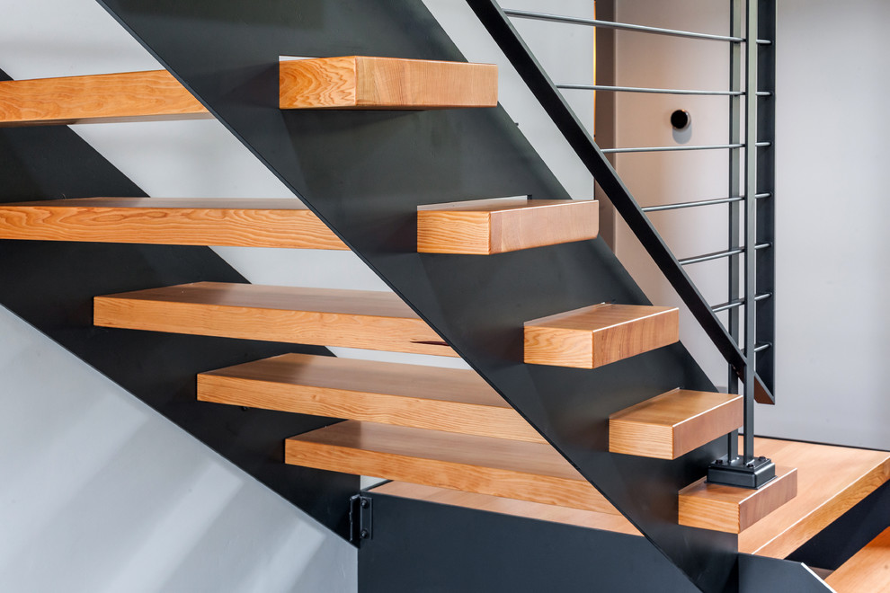 This is an example of a modern wood staircase in Portland with open risers.