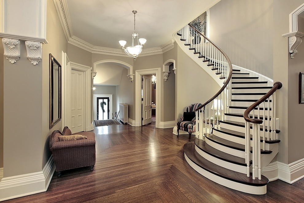 Стильный дизайн: большая изогнутая деревянная лестница в стиле рустика с деревянными ступенями - последний тренд
