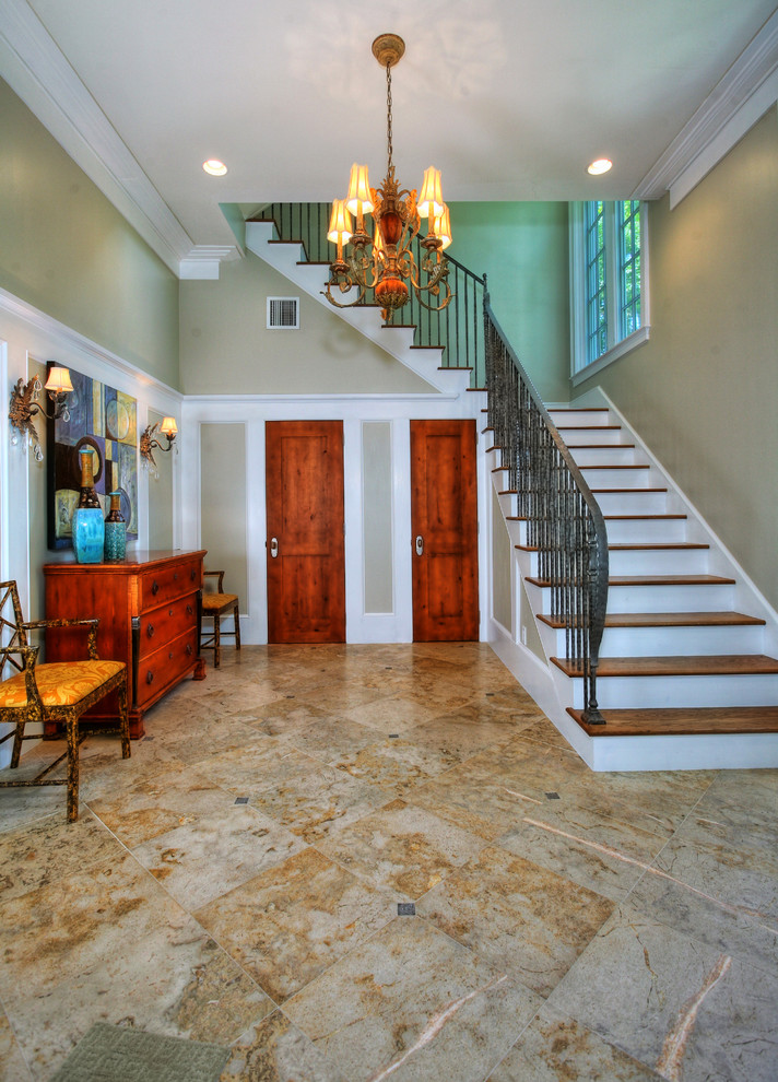 Island style wooden l-shaped metal railing staircase photo in Tampa with painted risers