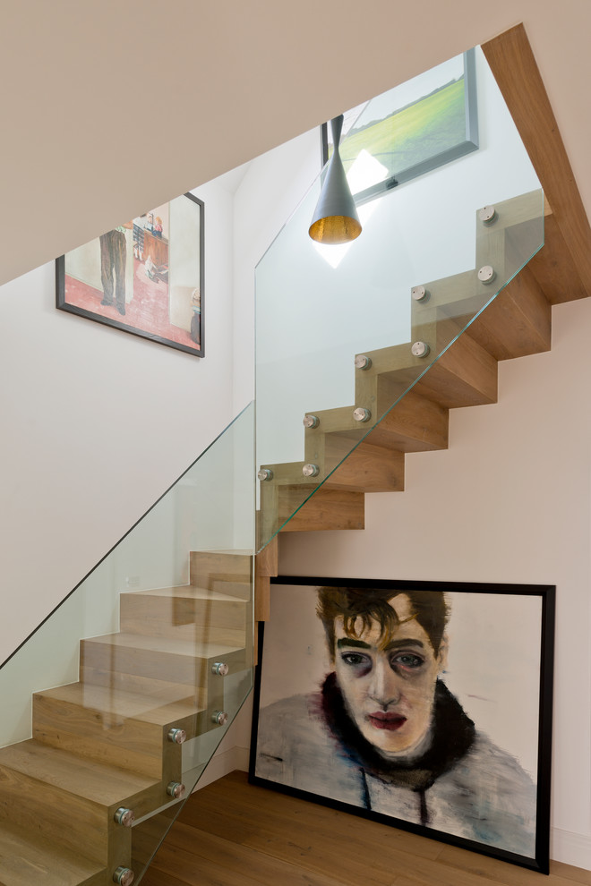 ロンドンにある高級な中くらいなコンテンポラリースタイルのおしゃれな階段 (木の蹴込み板) の写真