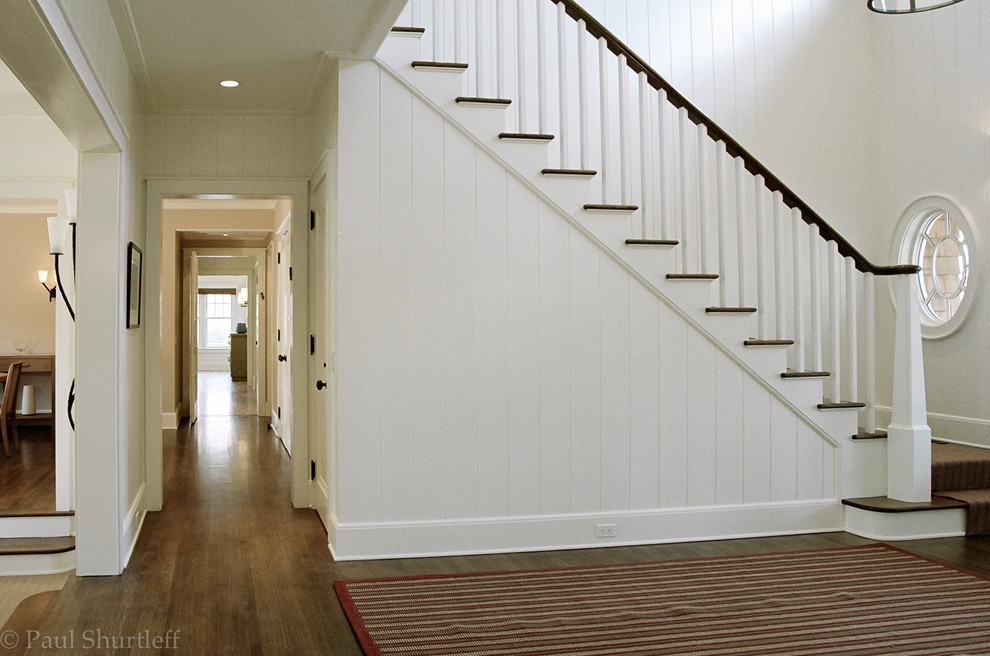 Photo of a medium sized traditional wood l-shaped staircase in New York with painted wood risers.