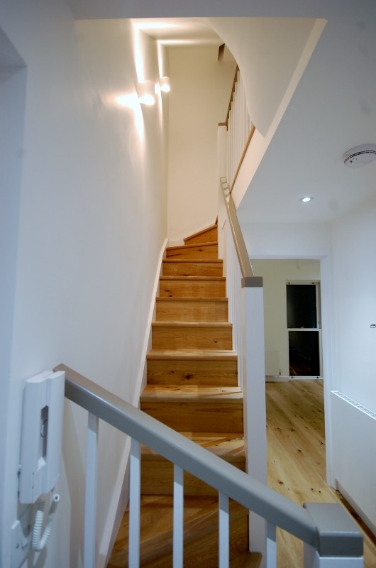 Diseño de escalera recta contemporánea pequeña con escalones de madera y contrahuellas de madera