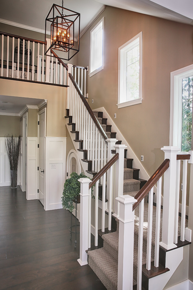 Design ideas for a classic wood u-shaped staircase in Detroit with wood risers.