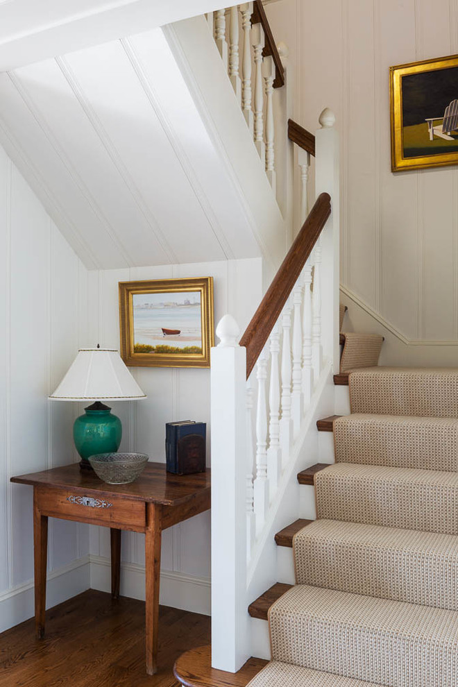 Inspiration for a mid-sized timeless wooden u-shaped staircase remodel in Boston with painted risers