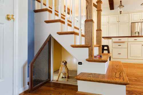 Under the stairs dog room with vented door. 
