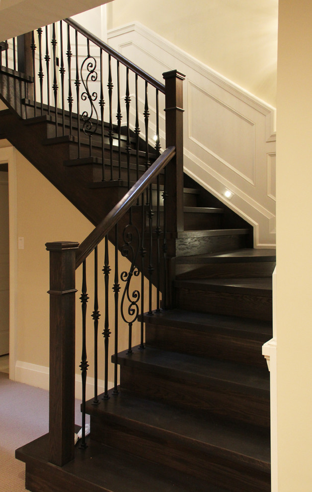 Classic wood l-shaped wood railing staircase in Toronto with wood risers.