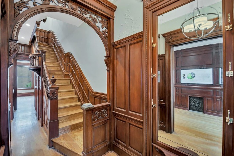 На фото: огромная прямая деревянная лестница в викторианском стиле с деревянными ступенями и деревянными перилами