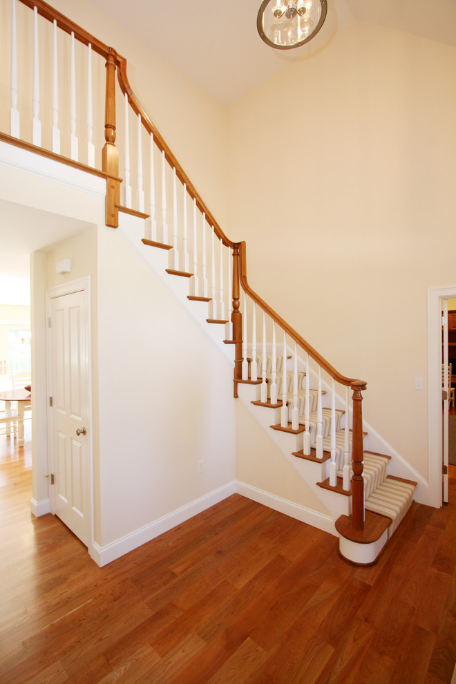 Design ideas for a medium sized traditional wood l-shaped staircase in Boston with wood risers.