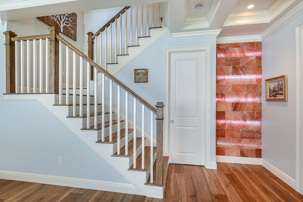 Mid-sized transitional wooden u-shaped staircase photo in Tampa with tile risers