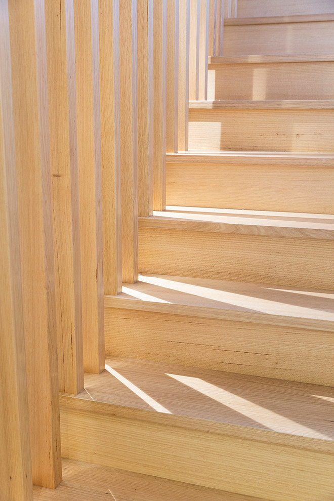 This is an example of a medium sized contemporary wood floating staircase in Melbourne with open risers.