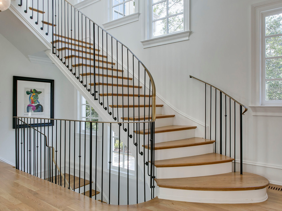 Inspiration for a transitional wooden l-shaped metal railing staircase remodel in Raleigh with wooden risers
