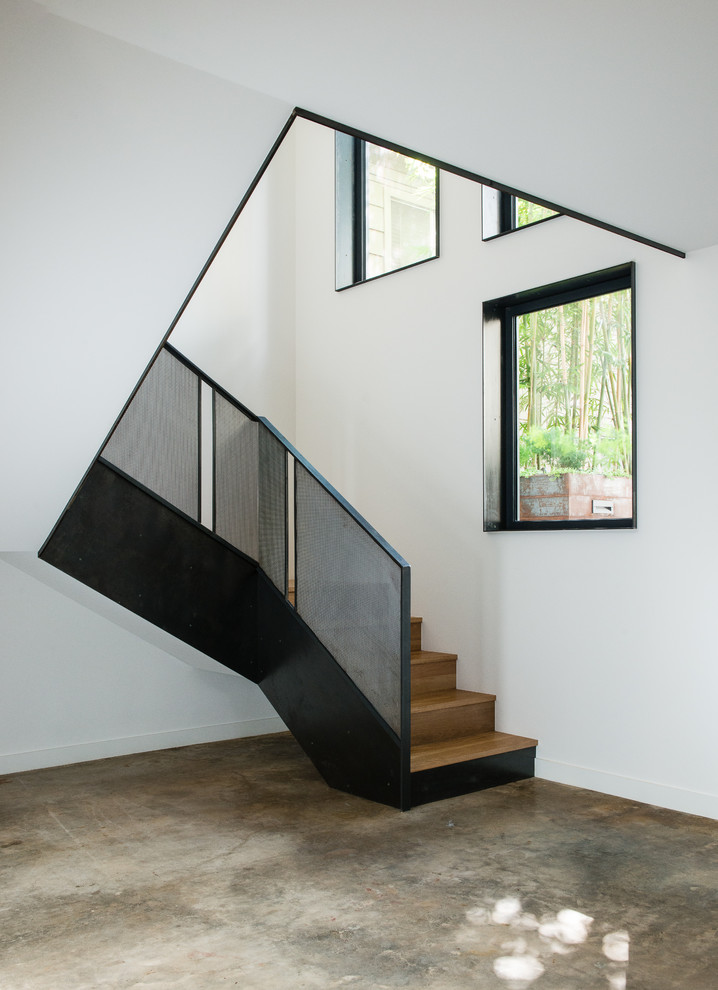 Mid-sized trendy wooden u-shaped metal railing staircase photo in Austin with wooden risers