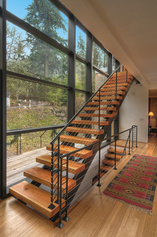 Contemporary wood straight staircase in Other with open risers.