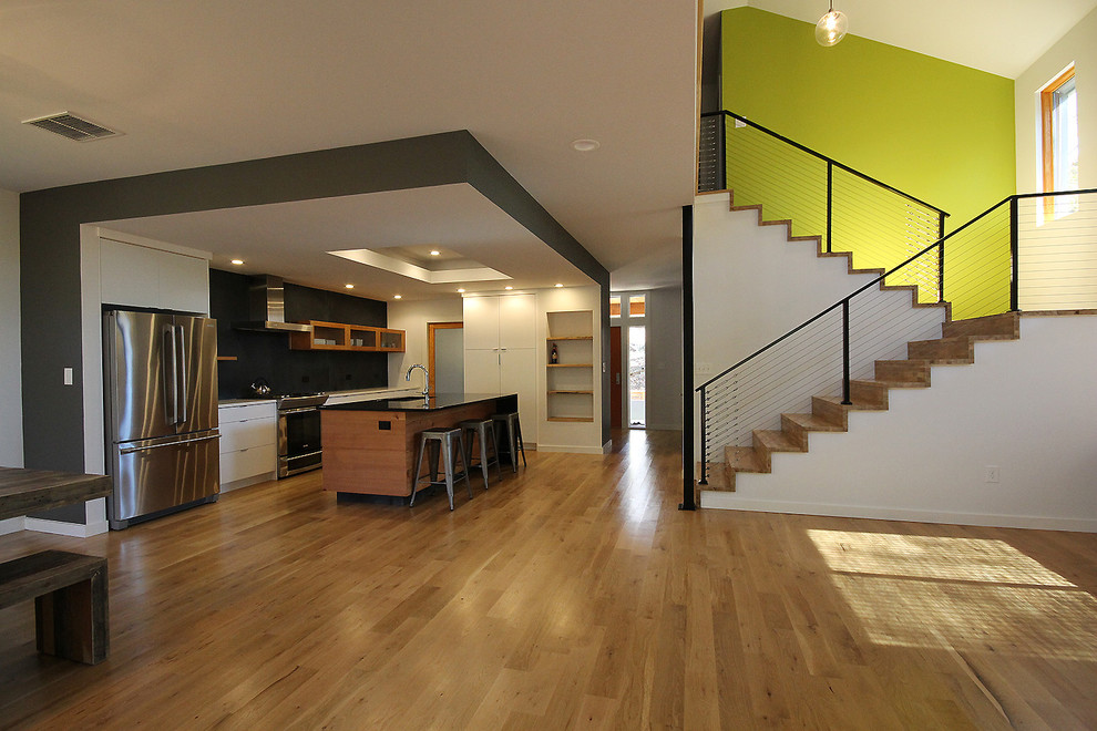 Photo of a contemporary wood u-shaped staircase in Atlanta with wood risers.
