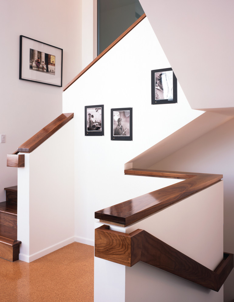 Large minimalist wooden u-shaped staircase photo in Los Angeles with wooden risers
