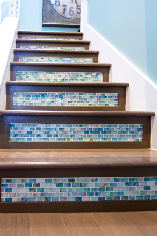 Modelo de escalera en U tropical grande con escalones de madera y contrahuellas con baldosas y/o azulejos