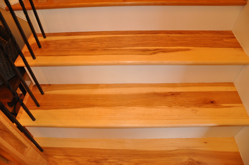 Large traditional wood l-shaped staircase in Charlotte with painted wood risers.