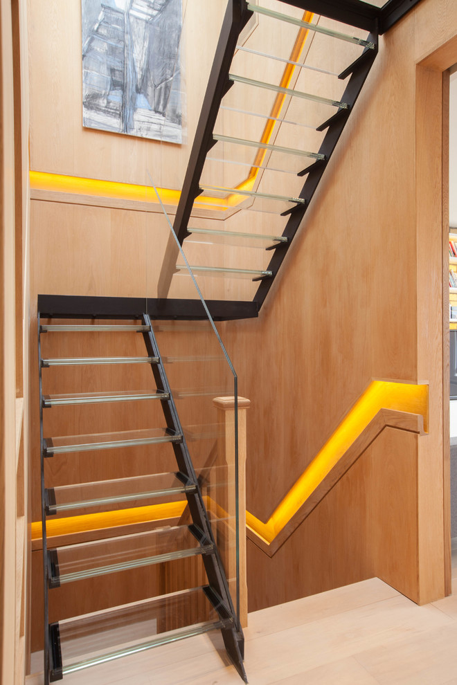 This is an example of a contemporary glass u-shaped staircase in London with open risers.