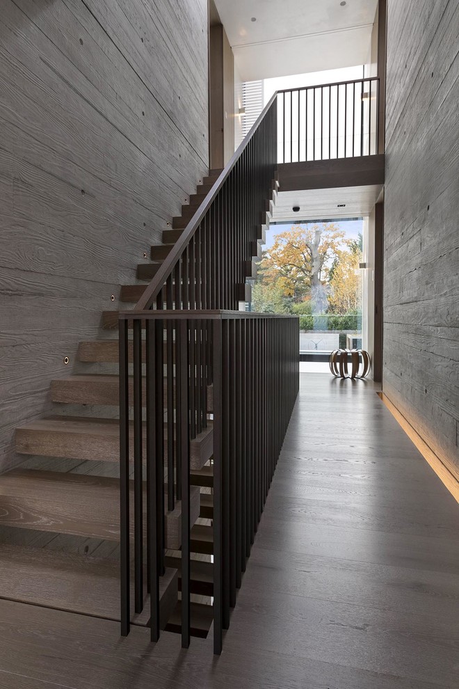 Idées déco pour un escalier droit moderne de taille moyenne avec des marches en bois et un garde-corps en bois.