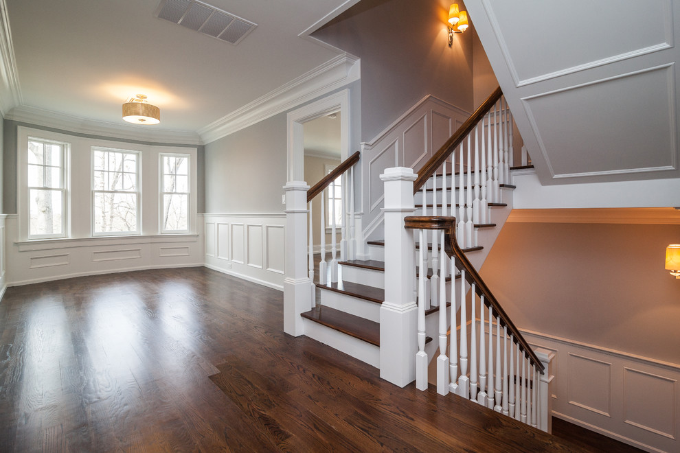 Inspiration for a mid-sized transitional wooden l-shaped staircase remodel in New York with painted risers