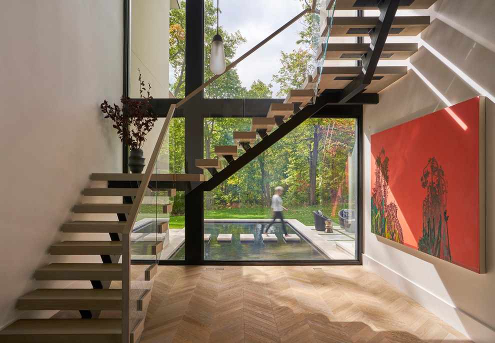 Ejemplo de escalera en L contemporánea sin contrahuella con escalones de madera y barandilla de varios materiales