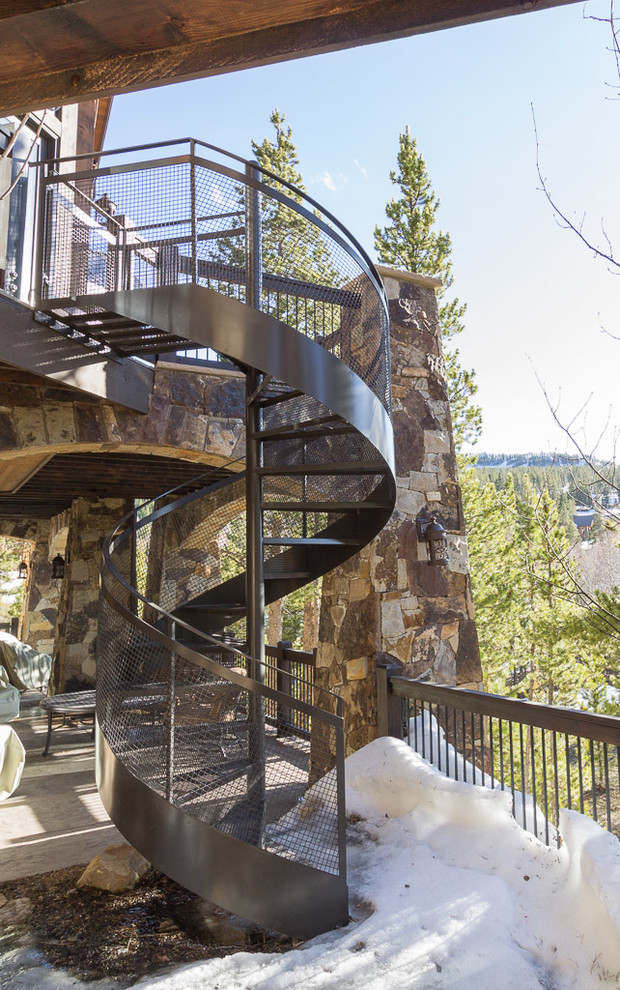 Example of a mid-sized mountain style metal spiral open staircase design in Denver