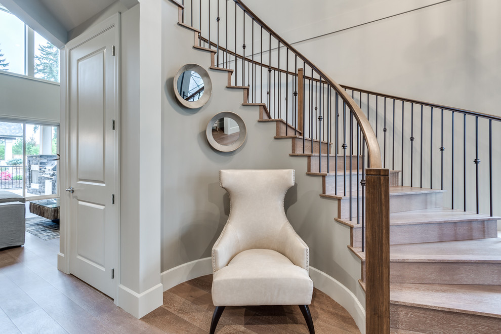 Classic curved mixed railing staircase in Vancouver with wood risers.