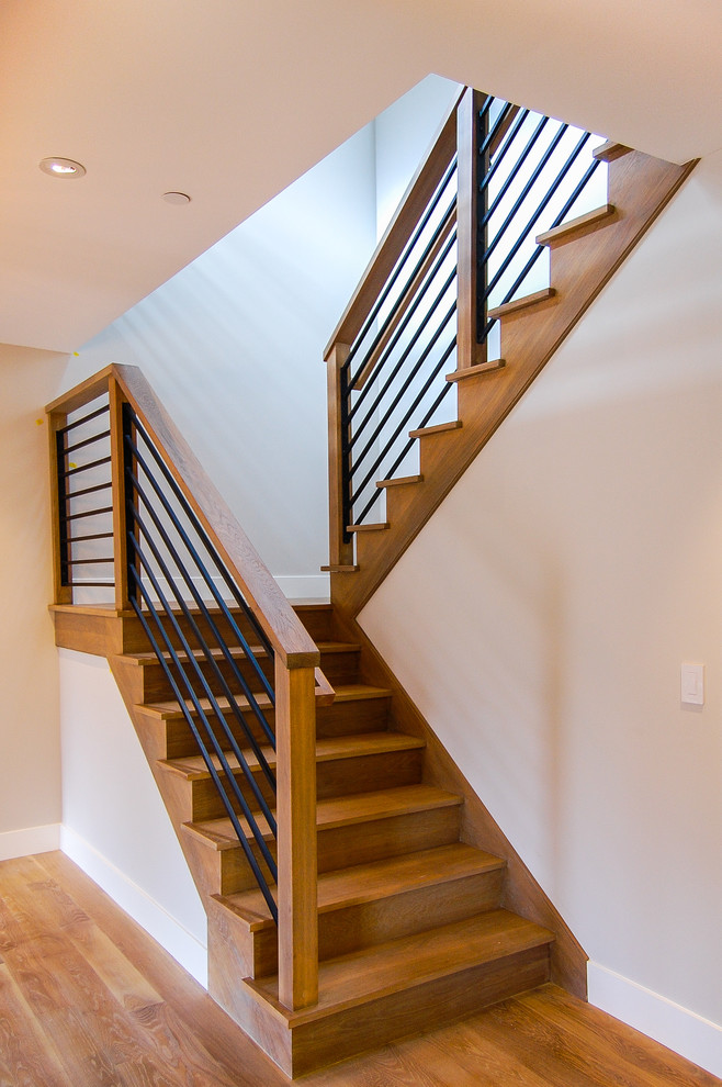 Photo of a classic wood u-shaped staircase in San Francisco with wood risers.