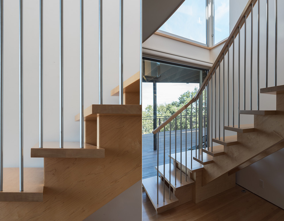 Photo of a large contemporary wood curved staircase in San Francisco with open risers.