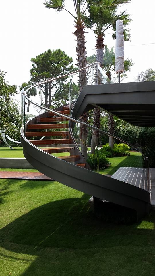 Идея дизайна: лестница в современном стиле с деревянными ступенями и металлическими перилами без подступенок