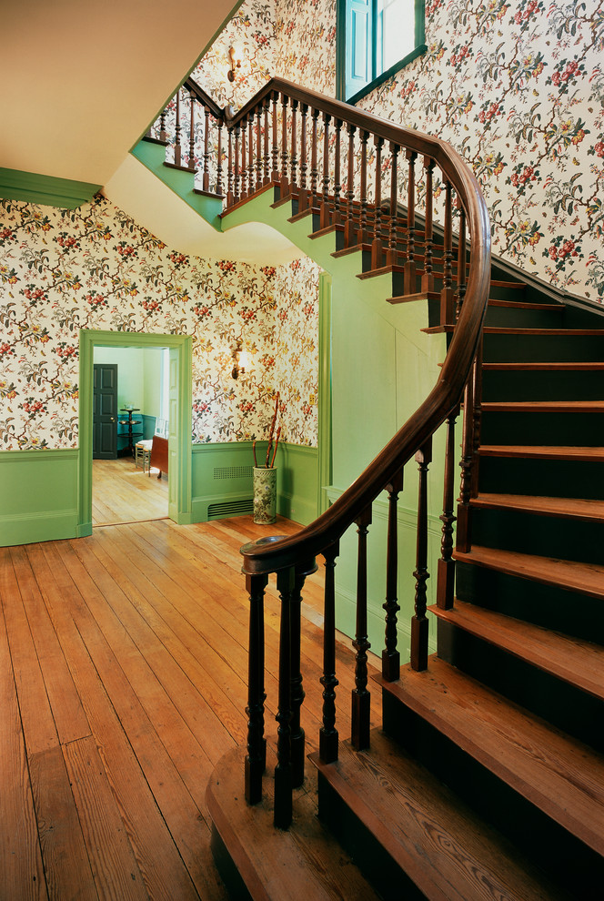 Photo of a medium sized traditional wood curved staircase in Richmond with wood risers.