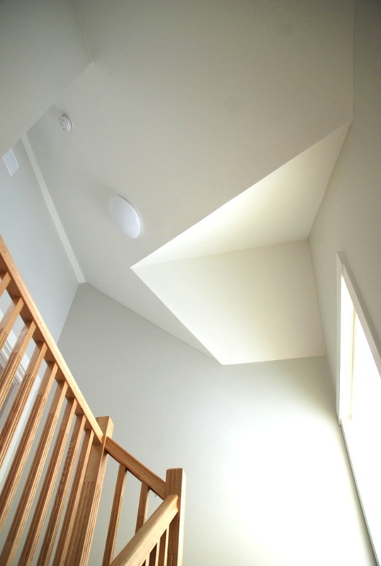 Inspiration for a mid-sized transitional wooden l-shaped staircase remodel in Detroit with wooden risers