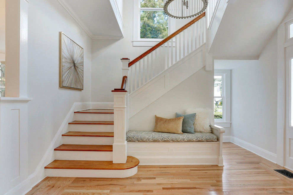 Photo of a large traditional wood l-shaped wood railing staircase in Tampa with wood risers.