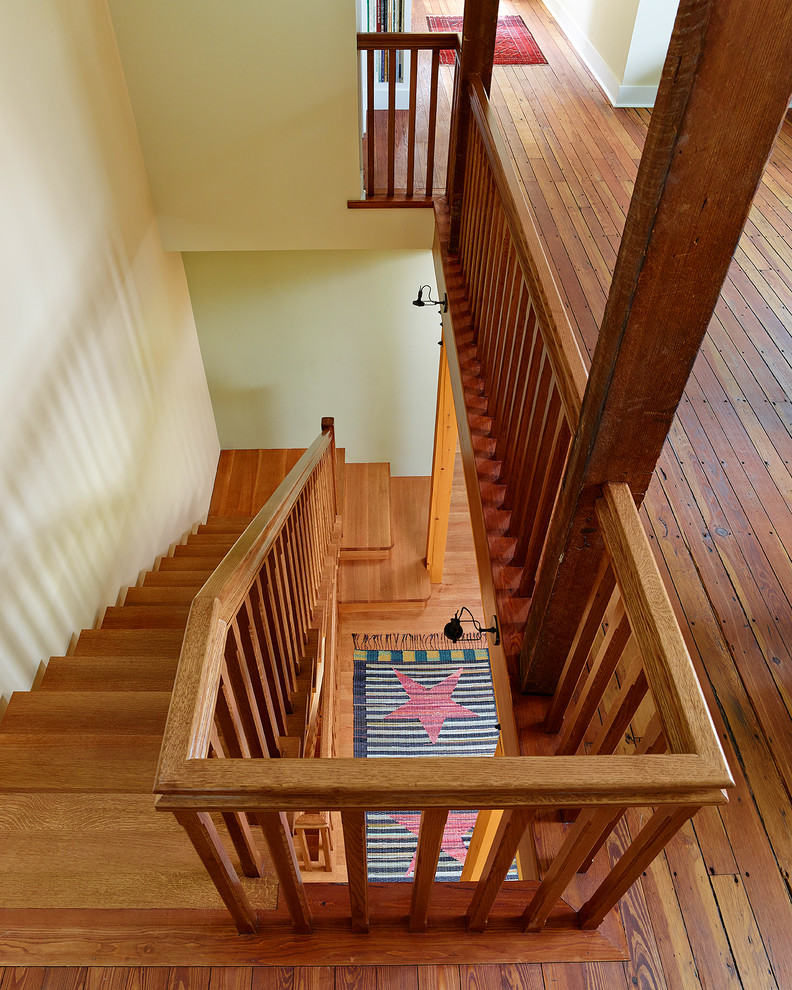 This is an example of a large country wood straight staircase in Philadelphia with wood risers.