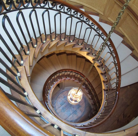 Photo of a victorian wood spiral staircase in New York with wood risers.
