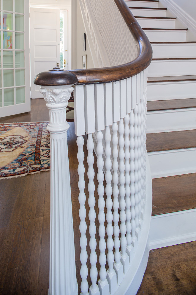 Large elegant wooden straight staircase photo in Atlanta with painted risers