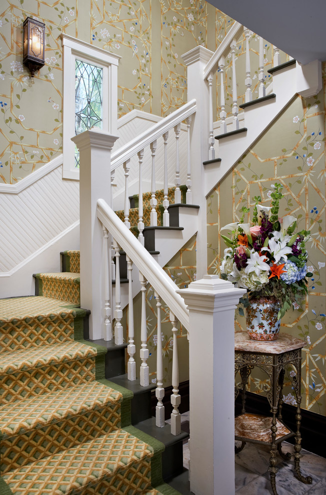 This is an example of a traditional painted wood u-shaped staircase in Other with painted wood risers.