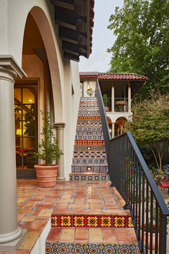 Inspiration for an expansive mediterranean straight metal railing staircase in Dallas with terracotta treads and tiled risers.