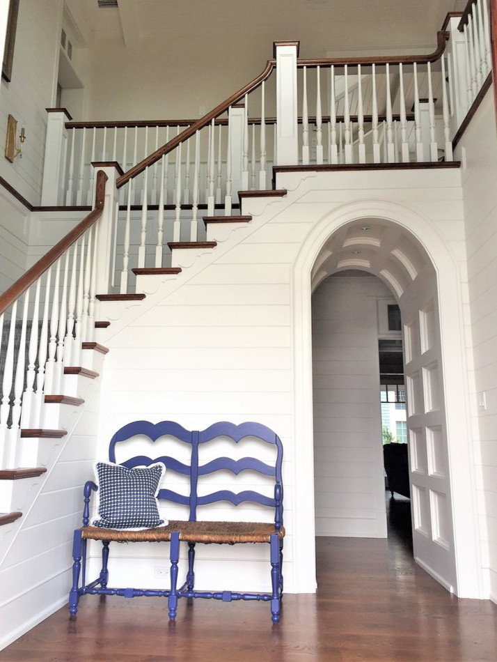 Photo of a coastal wood wood railing staircase in Philadelphia with painted wood risers.