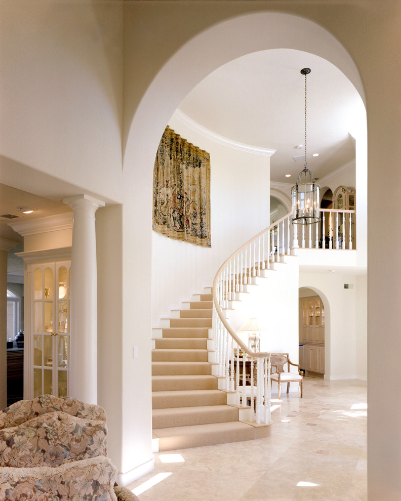 Inspiration for a large timeless wooden curved staircase remodel in Albuquerque with painted risers