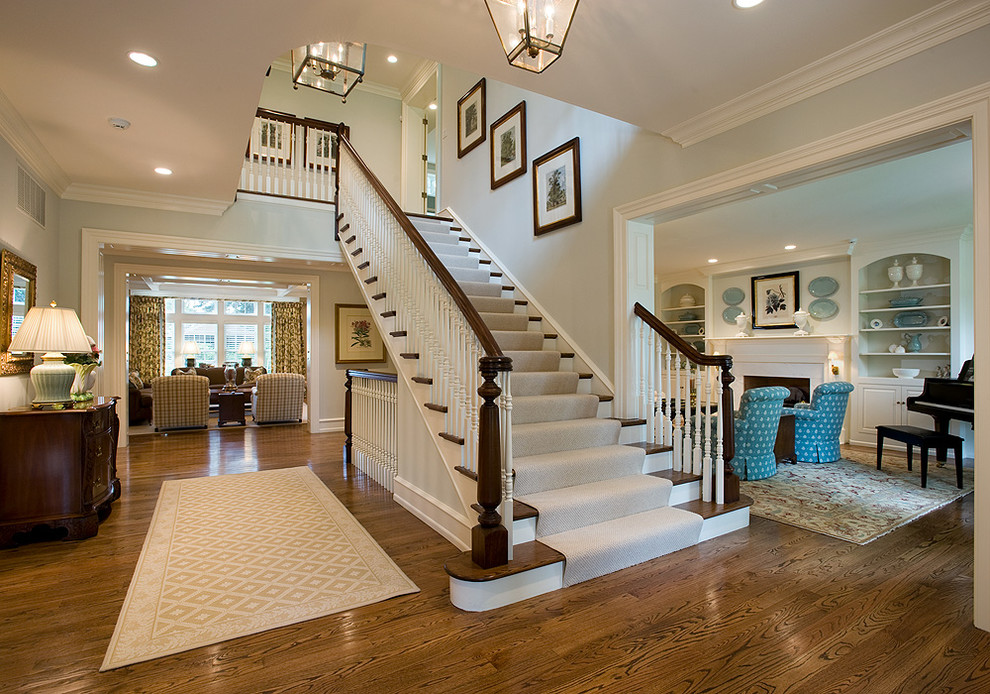 Diseño de escalera recta clásica renovada de tamaño medio con escalones de madera, contrahuellas de madera pintada y barandilla de madera