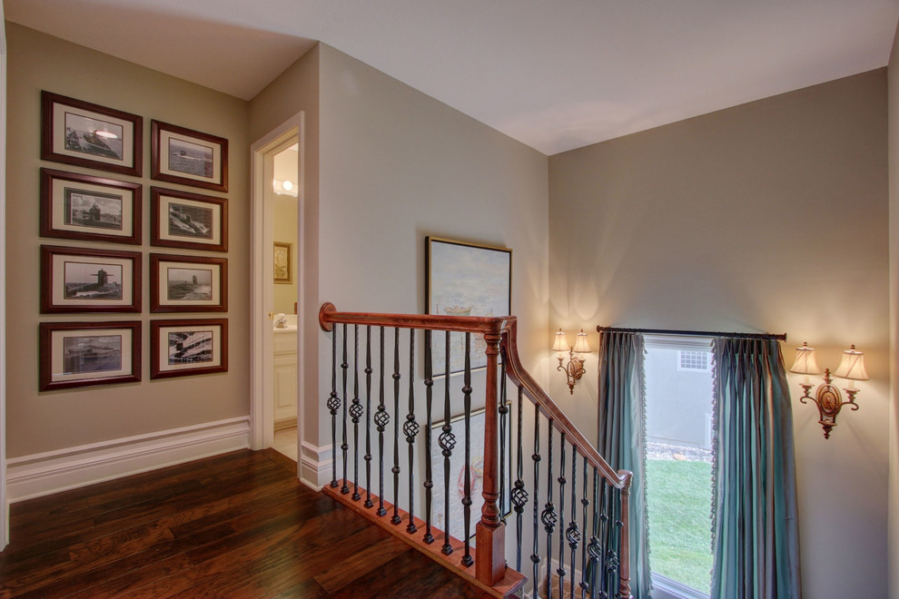 This is an example of a medium sized traditional carpeted u-shaped staircase in Kansas City with carpeted risers.