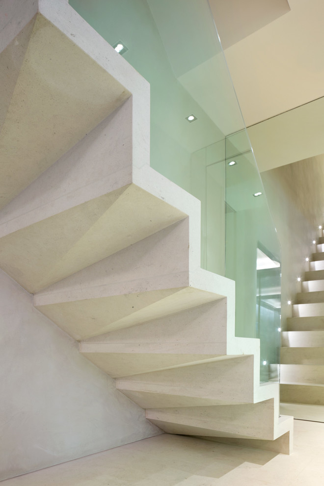 This is an example of a medium sized contemporary straight glass railing staircase in London.