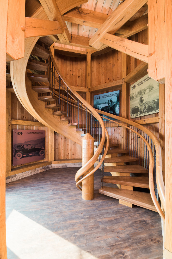 Expansive country wood floating staircase in Columbus with open risers.