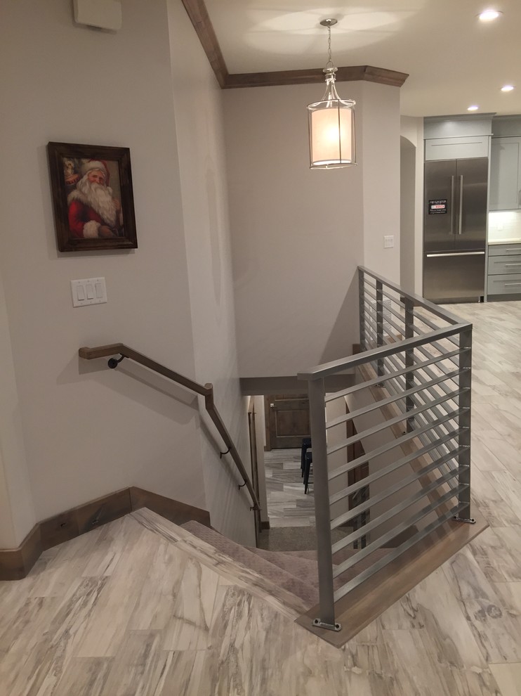 Large trendy wooden u-shaped staircase photo in Salt Lake City with wooden risers