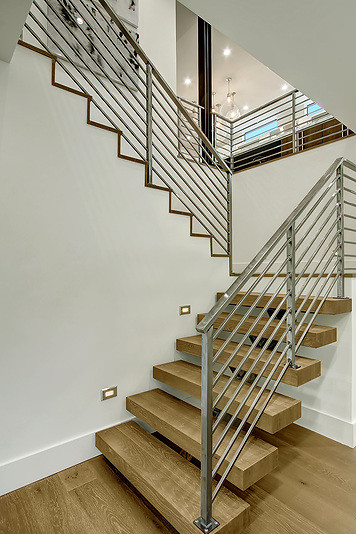 Photo of a medium sized modern wood floating staircase in Seattle with open risers.