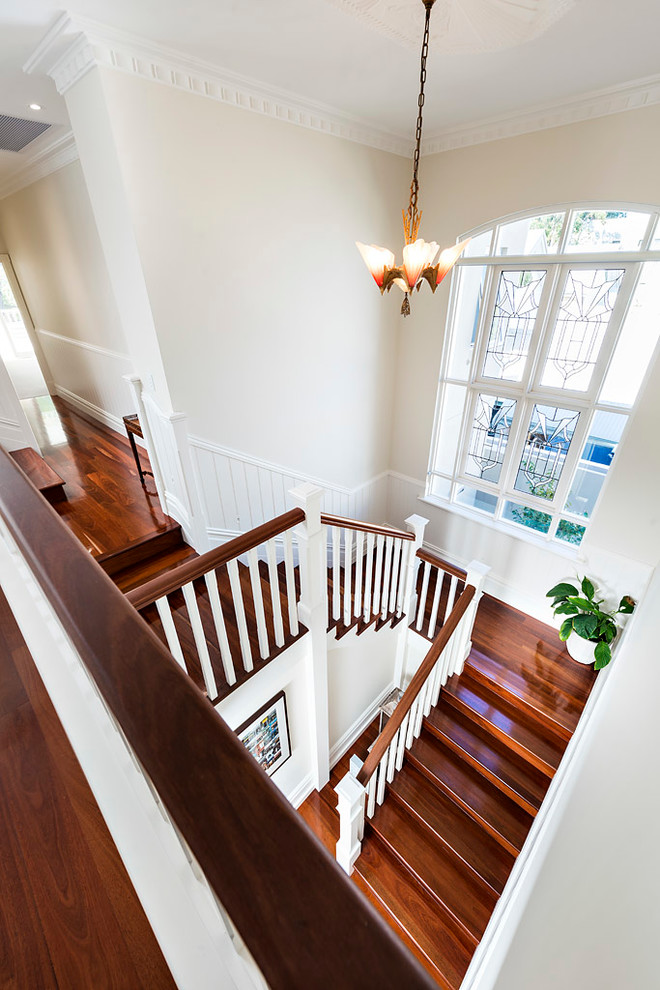 Large elegant wooden u-shaped wood railing staircase photo in Perth with wooden risers